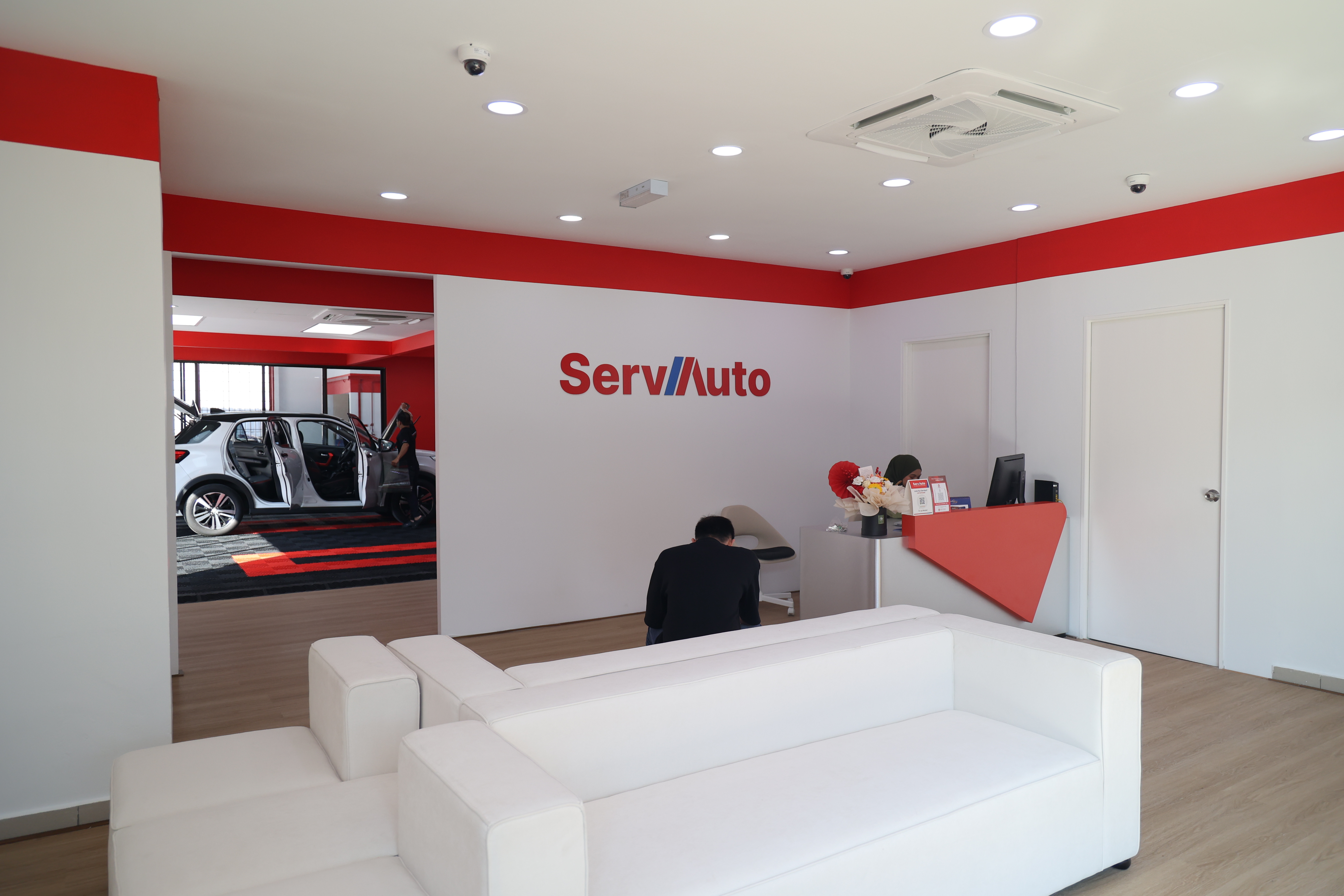 ServAuto store customer waiting area with view into service bays